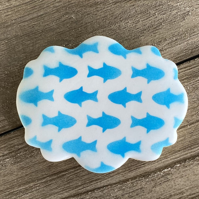 Fish Pattern Cookie Stencil is airbrushed in blue on a plaque shaped cookie.