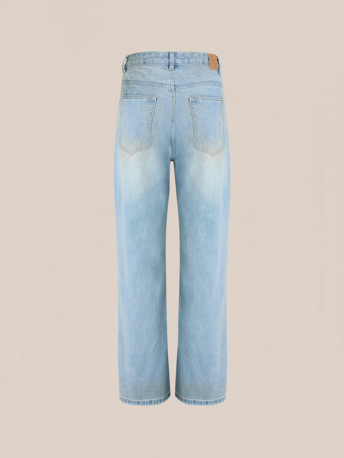 The Found Flare Jeans in light blue denim are shown from the back with two back pockets, distressed hems, and a wide-leg cut, displayed against a plain beige background.