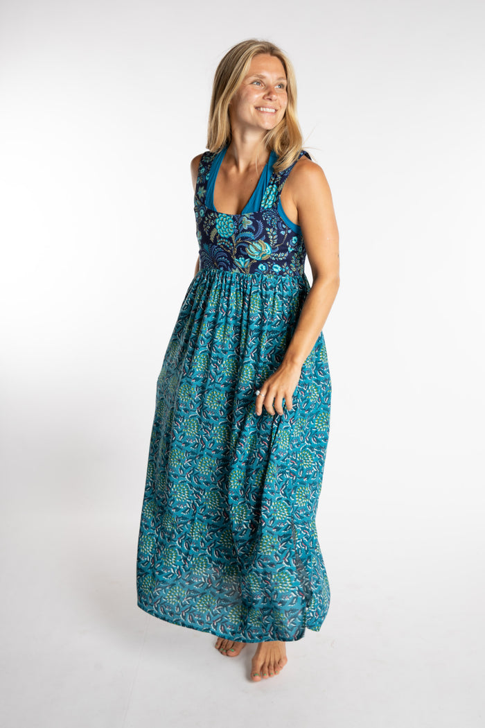Sophie wearing the S/M teal floral Flora Fusion maxi dress with cobalt yantra wrap top