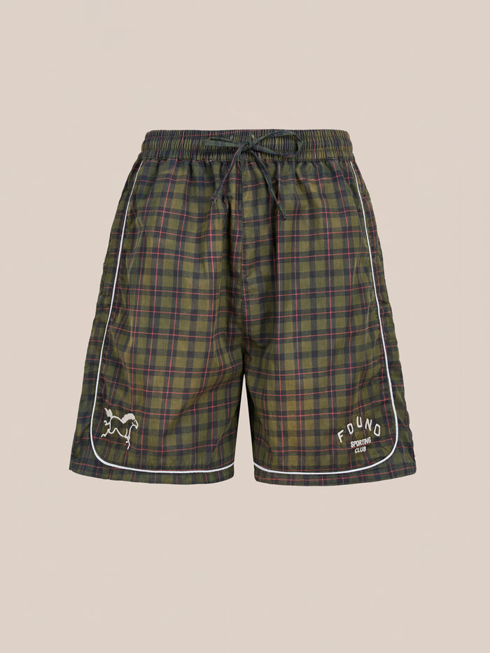 Found’s Forest Plaid Track Shorts feature a green and blue plaid design, drawstring waistband, white piping, and embroidered logos. These unisex vintage athletic shorts offer a relaxed fit for classic comfort and sporty style.