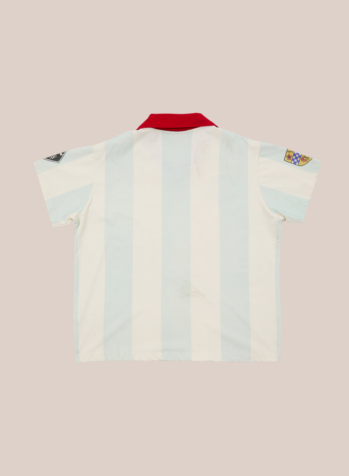 Introducing the FOUND Found Club Short Sleeve Jersey: a short-sleeved jersey featuring light blue and white stripes, a striking red collar, and two sleeve patches, displayed flat on a neutral background.