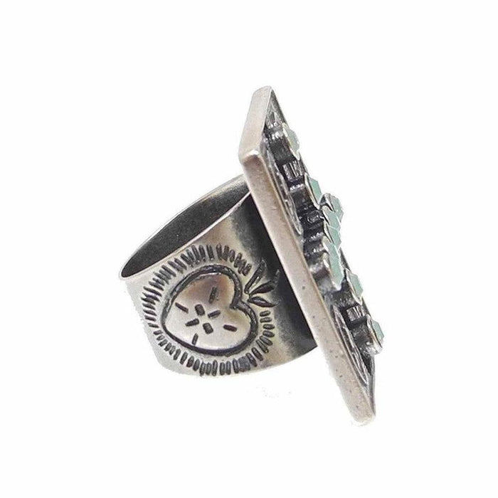 Sterling silver ring featuring a rectangular turquoise stone setting and engraved heart detail.