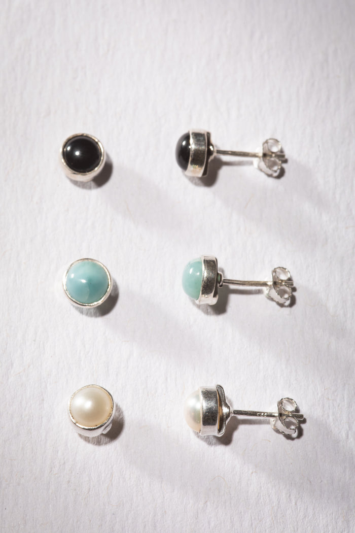 Gemstone earring stud trio in the theme of Sea and Sky. The studs are Onyx, Larimar, and Pearl