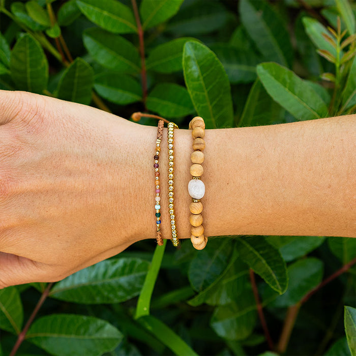 Gold 3mm Stretch Bead Bracelet, on wrist with greenery