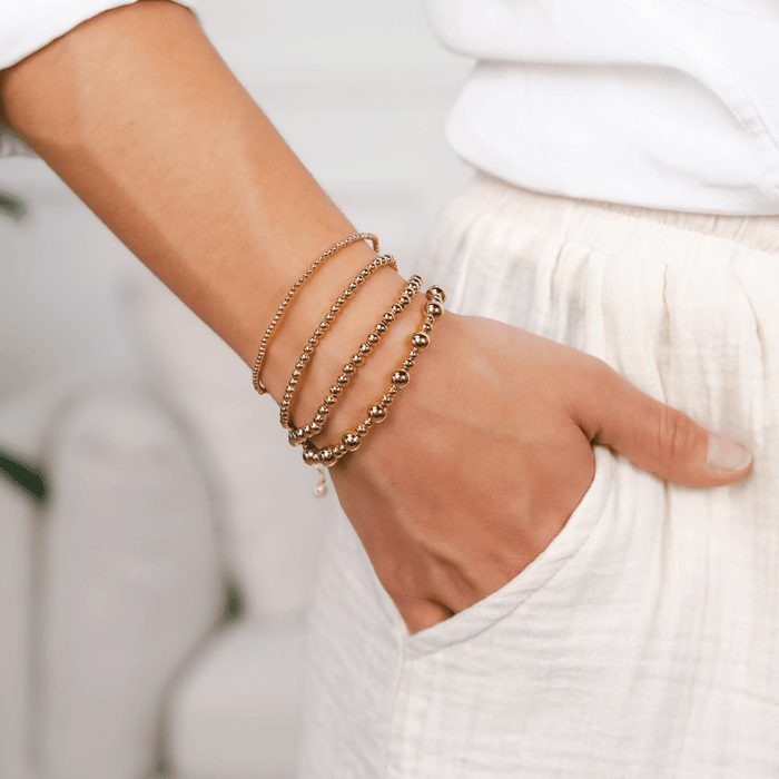 Gold 4mm Stretch Bead Bracelet, stacked on wrist