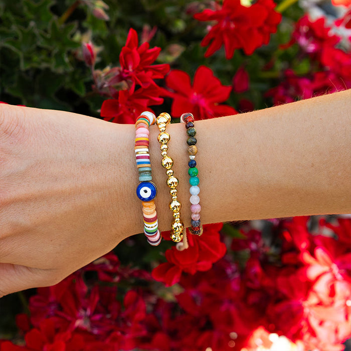 Gold Mixed Stretch Bead Bracelet, on wrist with red flowers