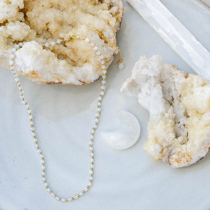Gold Moon Dancer 3mm Healing Necklace, flat lay with crystals