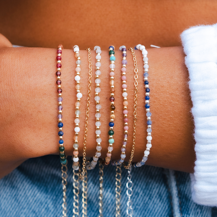 Good Fortune + Growth 2mm Layered Healing Bracelet, stacked on wrist over denim
