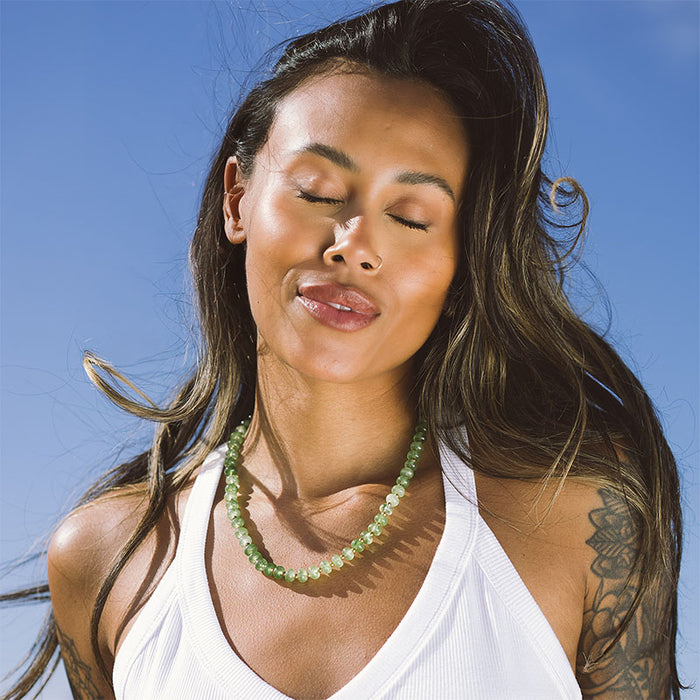 Good Fortune Statement Healing Necklace, worn against the sky