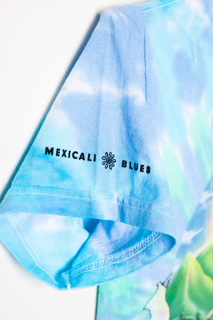 Tie-dye t-shirt with 'Mexicali Blues' logo on a light blue background