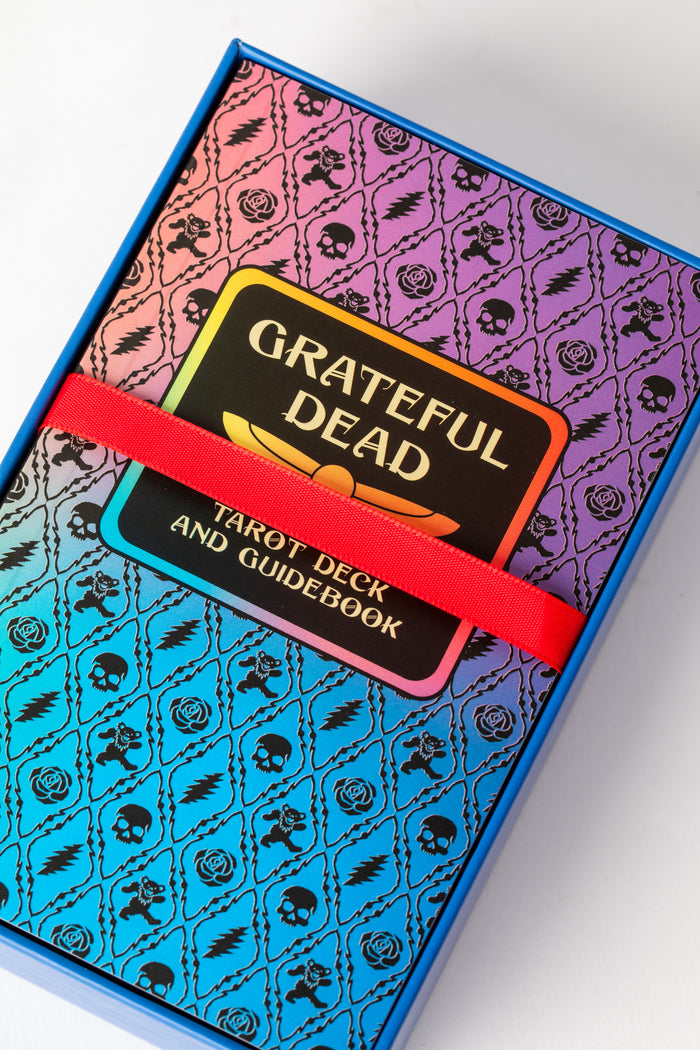 Grateful Dead Tarot guidebook with rainbow skull-and-rose pattern on cover in box.