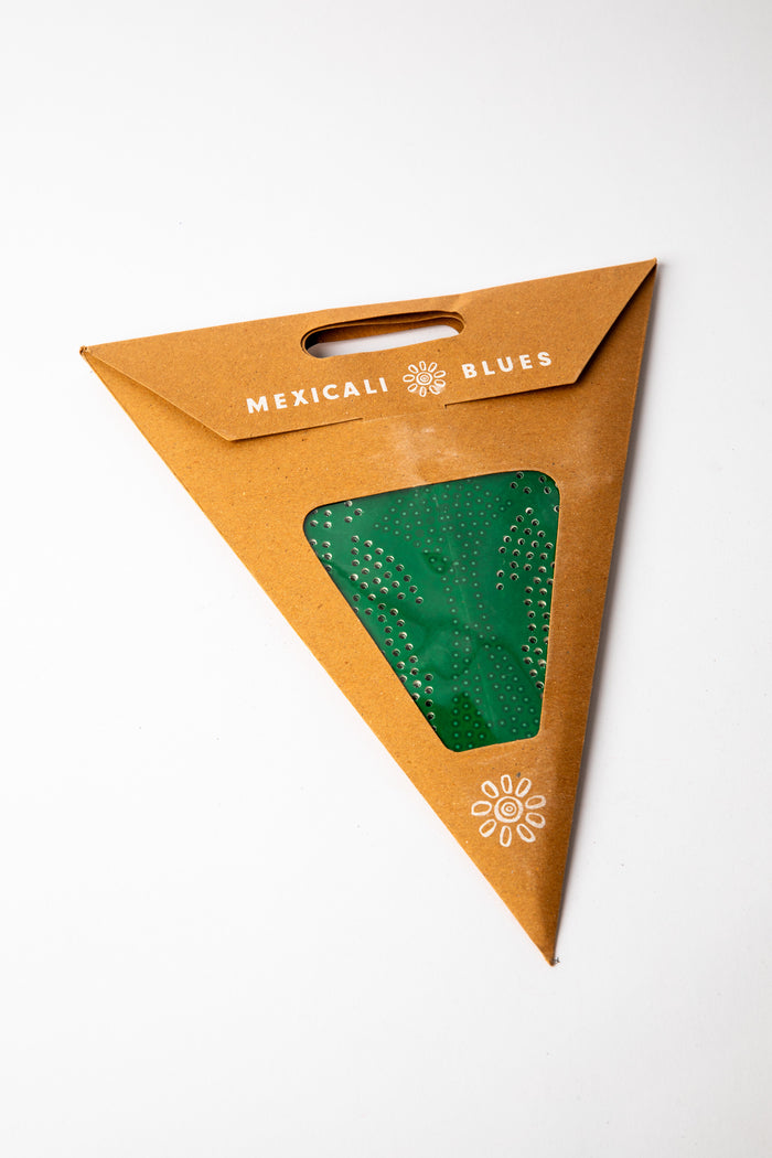 Green dotted embroidered paper star, folded up, in packaging