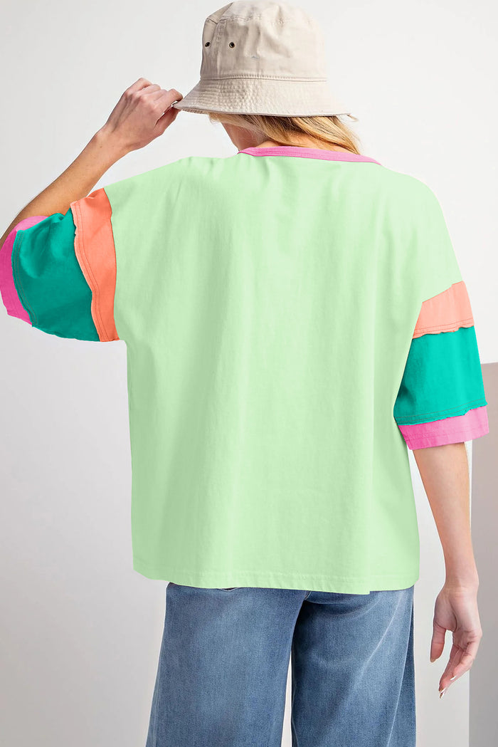 Haut oversize vert à manches et col rond avec coutures contrastées