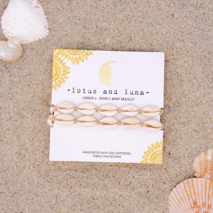 Hemp Cowry Shell Necklace, on brand card on sand