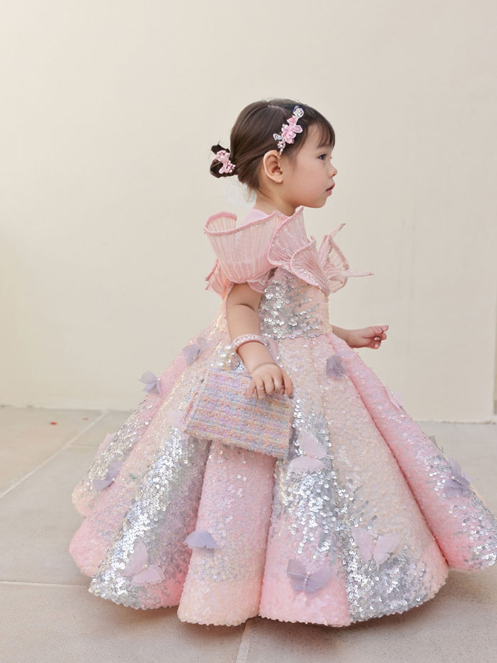 A stunning pink sequin gown with an ombre shine, wired neckline, and butterfly motifs‰ÛÓdesigned for birthdays and special celebrations.