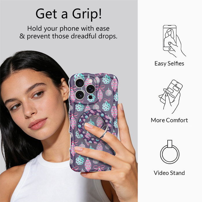 Woman taking a selfie while holding an iPhone by the Just One More Ornament grip ring; easy selfies, more comfort and video stand