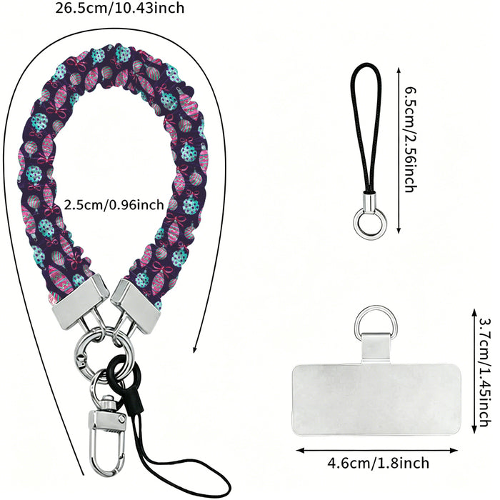 Just One More Ornament scrunchie wrist strap dimensions: 26.5 cm strap, 2.5 cm wide, 6.5 cm loop, 4.6 x 3.7 cm phone tab