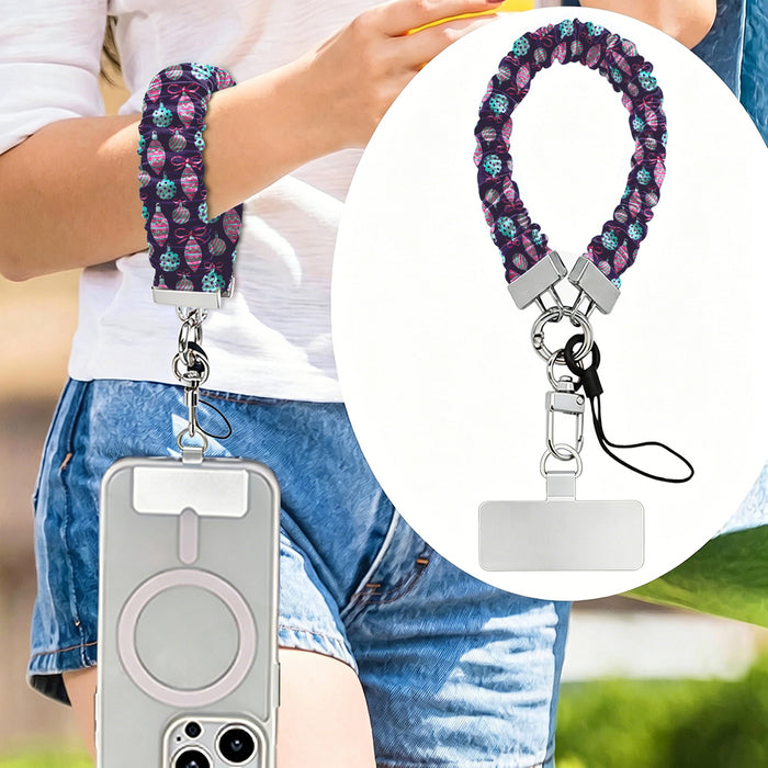 Just One More Ornament scrunchie phone strap worn on the wrist with an iPhone hanging from it, plus close-up of the strap and phone tab