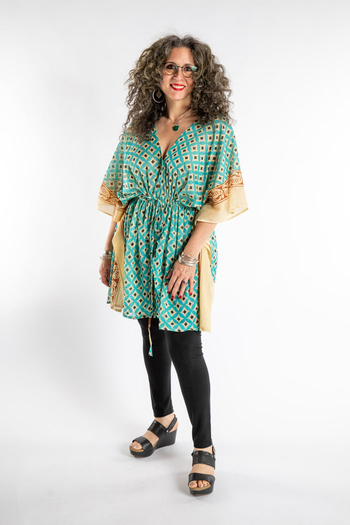 Susan is wearing the one size Kala Printed Cover Up in Teal