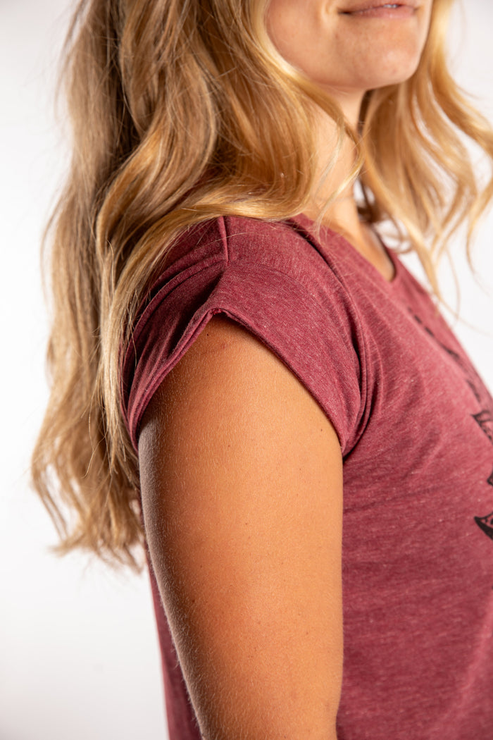 Sophie is wearing the Kali Graphic Crop T in Burgundy Heather in S/M