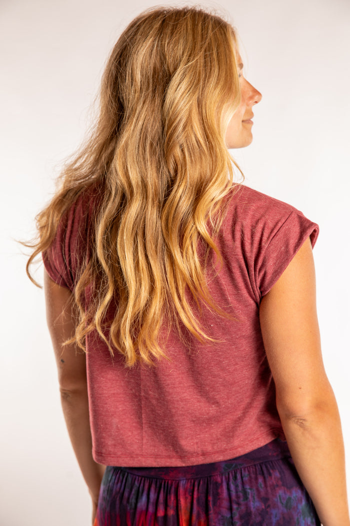 Sophie is wearing the Kali Graphic Crop T in Burgundy Heather in S/M