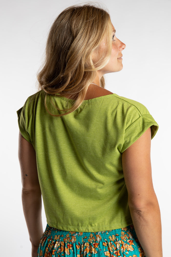 Sophie is wearing the Kali Graphic Crop T in Clover in S/M