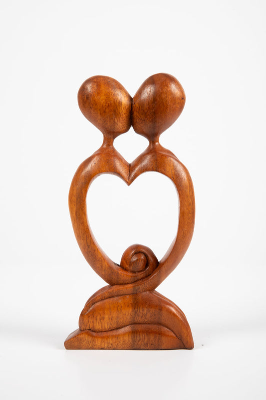 Kissing carved wooden sculpture in heart