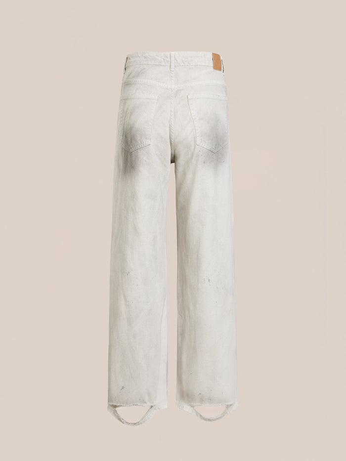 FOUND Lacy Baggy Jeans: Relaxed fit, wide-leg jeans in a light distressed concrete wash, seen from the back with two rear pockets and subtle faded details at seams and hem.