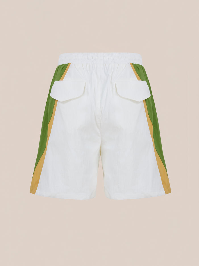 Found Legacy Cricket Track Shorts: White vintage-style shorts with green and tan side panels, elastic waistband, and two back flap pockets, shown on a neutral background.