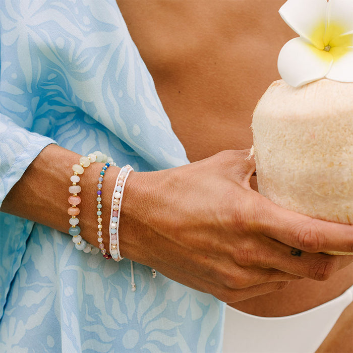 Live Free Statement Healing Bracelet, worn holding coconut