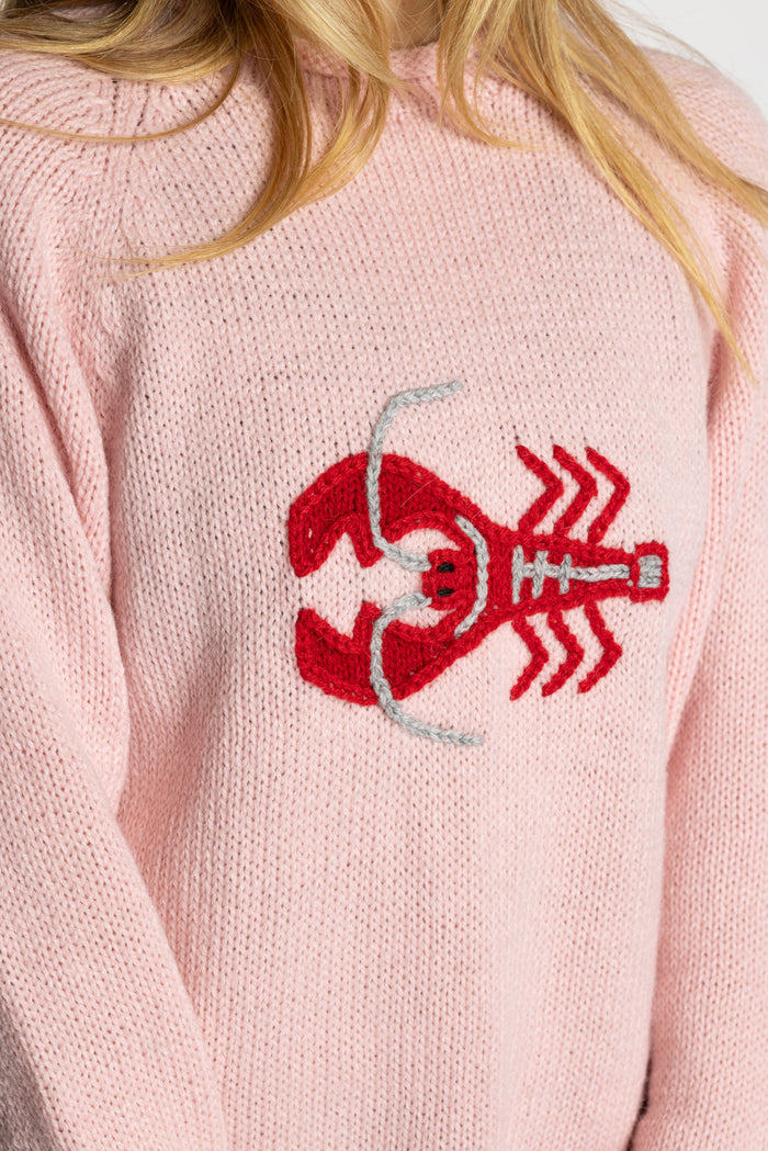 Sophie is wearing the Pink Lobster Alpaca Sweater in size S