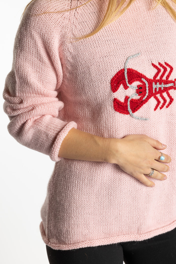Sophie is wearing the Pink Lobster Alpaca Sweater in size S