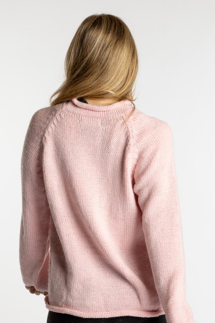 Sophie is wearing the Pink Lobster Alpaca Sweater in size S