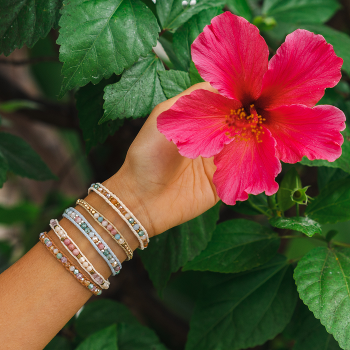 Lost Paradise Healing Bracelet, stacked on wrist with hibiscus