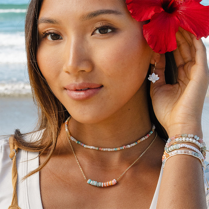 Lotus Bloom Earrings, worn on the beach