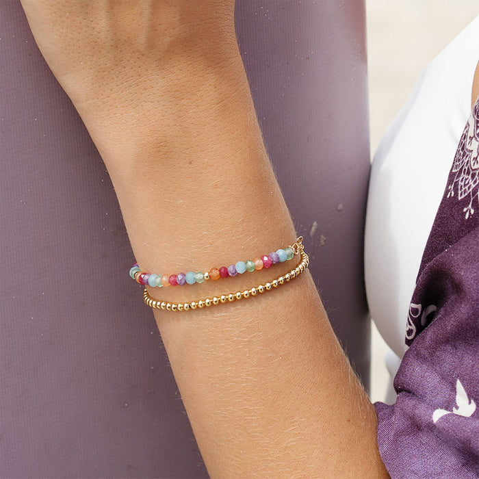 Lucky Charm 3mm Healing Bracelet, layered with gold bead bracelet on wrist