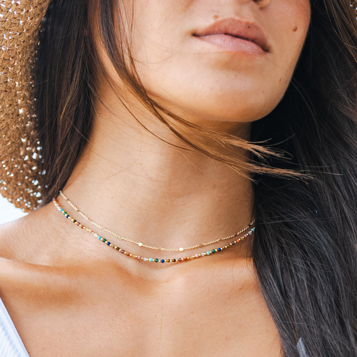 Master Healer 2mm Healing + Circles in the Sand Necklace Stack, worn with straw hat