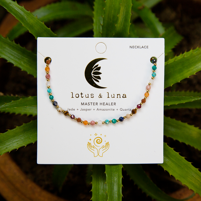 Master Healer 3mm + 2mm Necklace Stack, flat lay on card with plant