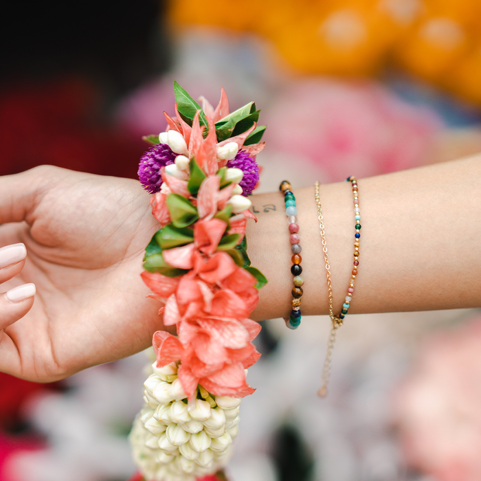 Master Healer 4mm Healing Bracelet, on wrist with flower garland
