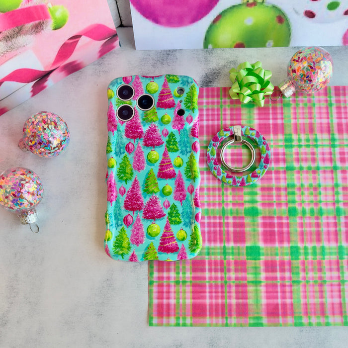 Merry & Bright, Totally! MagSafe grip ring lying beside the matching iPhone case on pink and green plaid with a lime gift bow