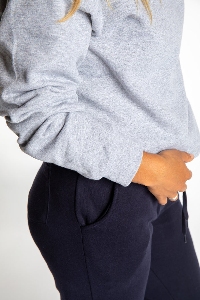 Sophie wearing a size S Heather Sport Gray branded crew neck