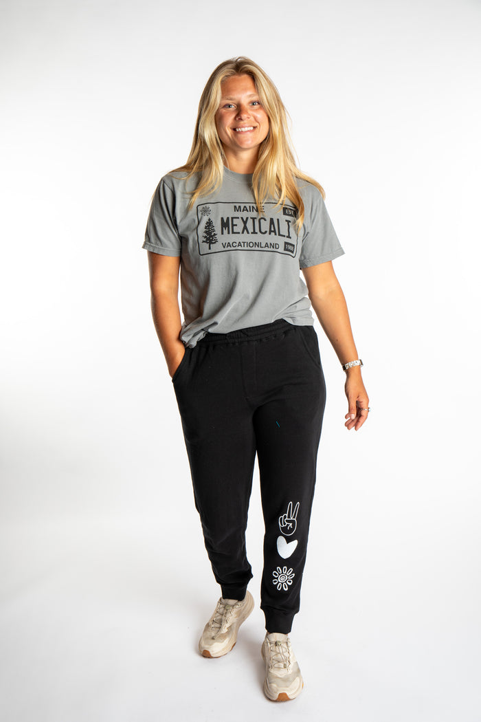Sophie wearing the size S Heather Gray License plate tee with black branded joggers