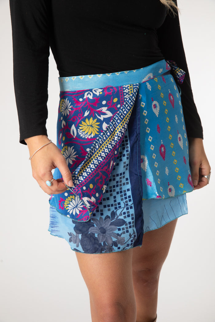 Sophie is wearing a silk wrap skirt in morning dew