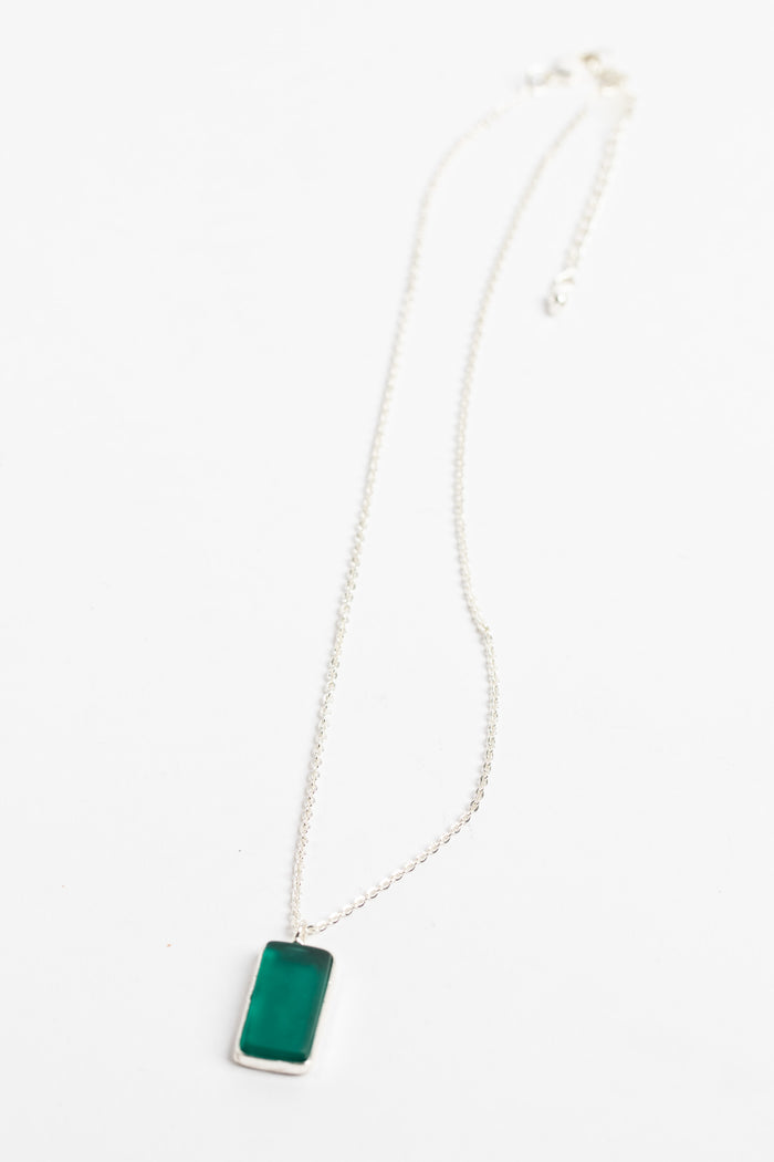 minimalist boho necklace pendant in teal on white background