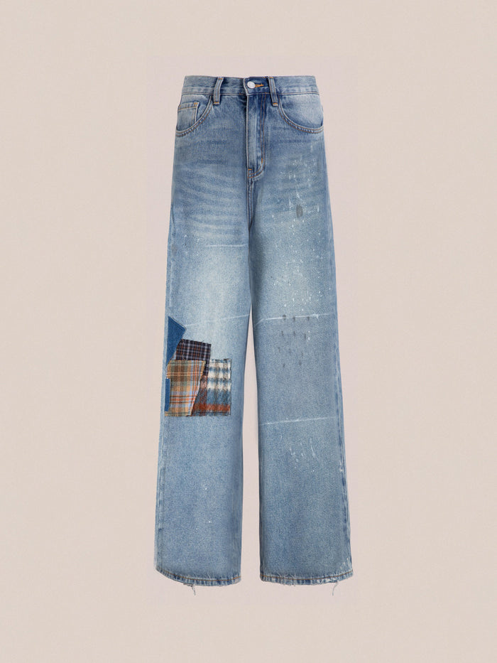 Introducing the Mix Patch Jeans by Profound: A pair of straight-leg jeans in light blue, designed with a vintage plaid patch and faded detailing on the front, set against a beige background and crafted from structured denim cotton.