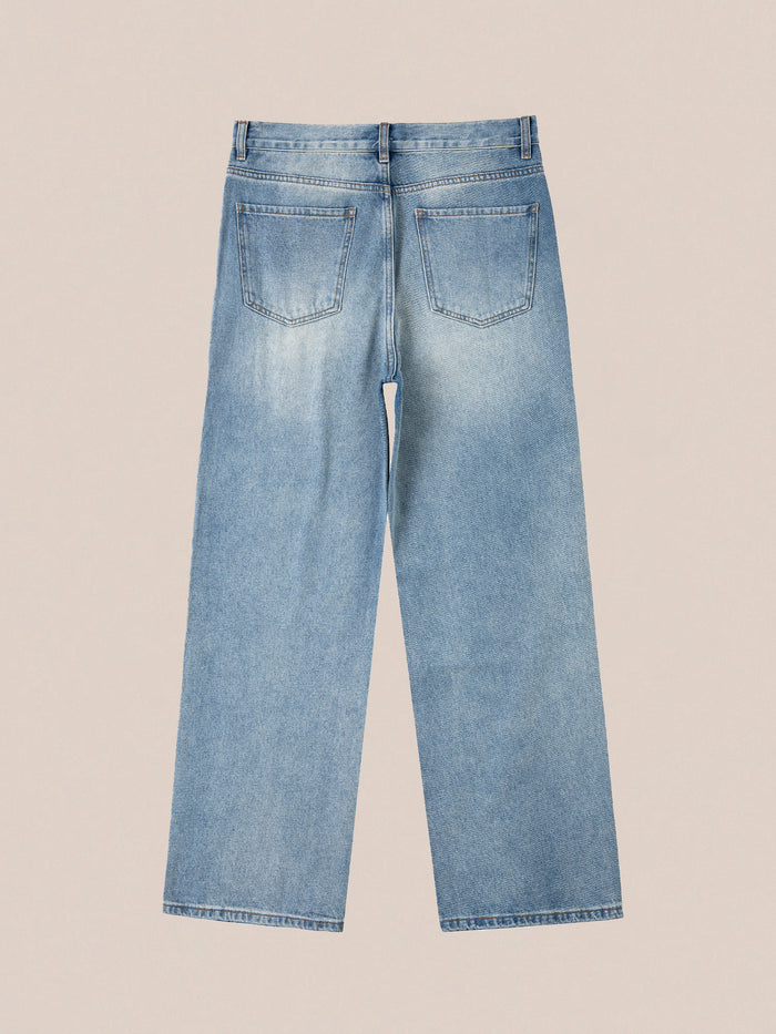 Back view of the Profound Mix Patch Jeans in light blue, crafted from structured denim cotton, featuring two back pockets on a plain background.