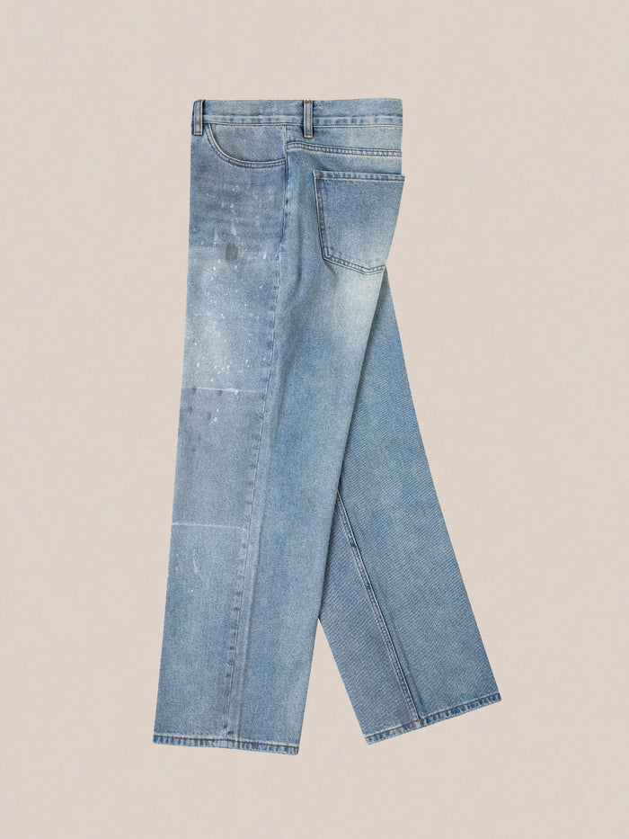 Introducing the Mix Patch Jeans from Profound: crafted from denim cotton, these jeans feature a straight-leg silhouette with a faded and patchwork design, beautifully displayed on a plain background.