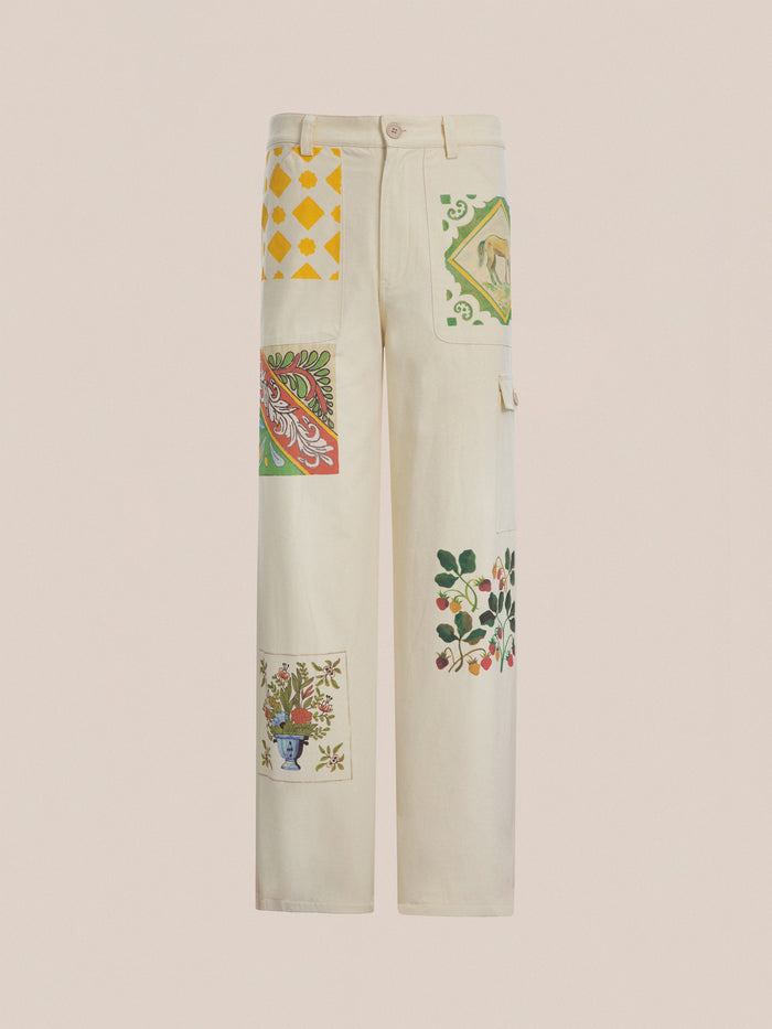 The unisex Mosaic Pants from FOUND feature a straight-cut design in cream with vibrant floral and geometric Indo-Aryan patchwork patterns.