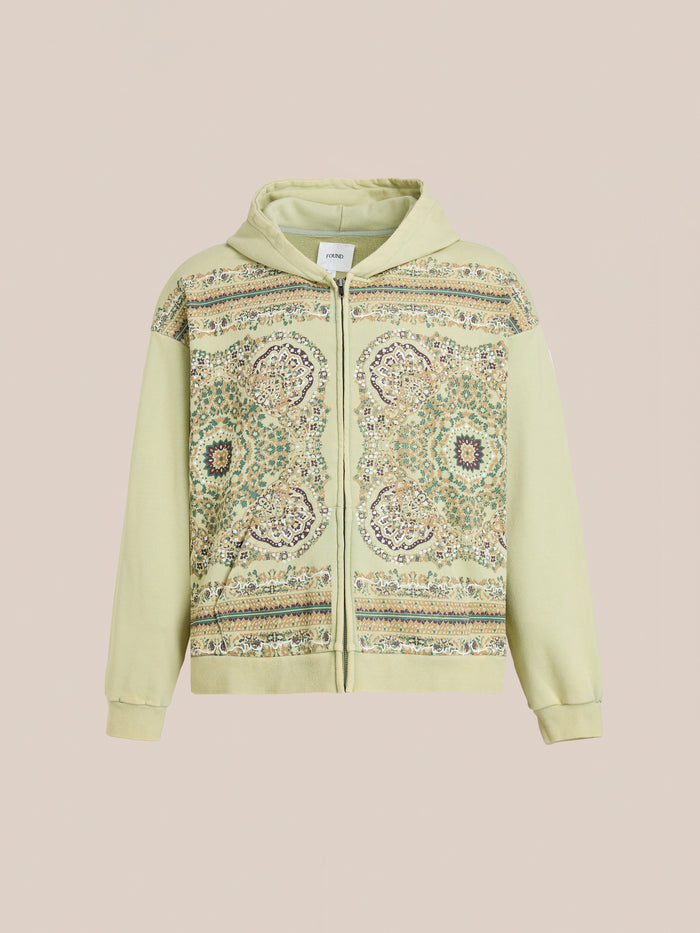 The FOUND Motif Zip-Up Hoodie in light green features a front panel with intricate multicolored geometric and floral mandala-inspired designs—a streetwear essential, showcased on a neutral background.
