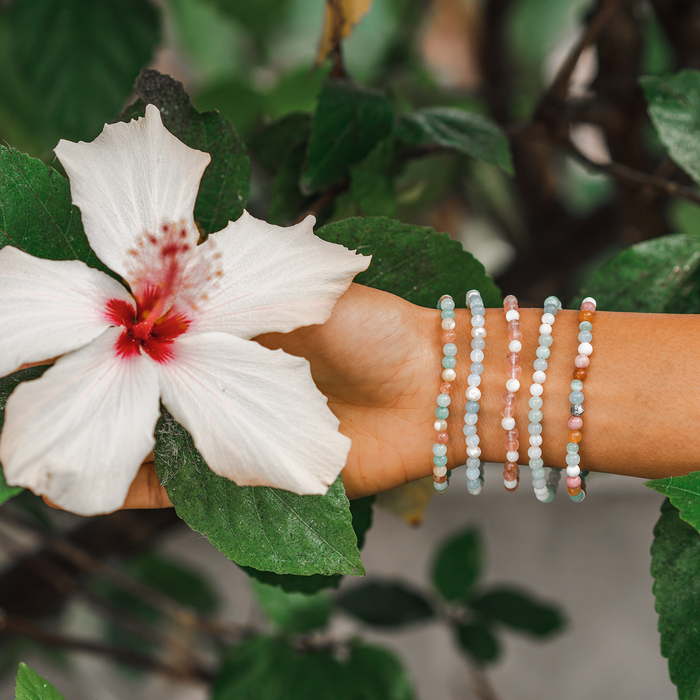Mystery Healing Bracelet, stacked on wrist with flower